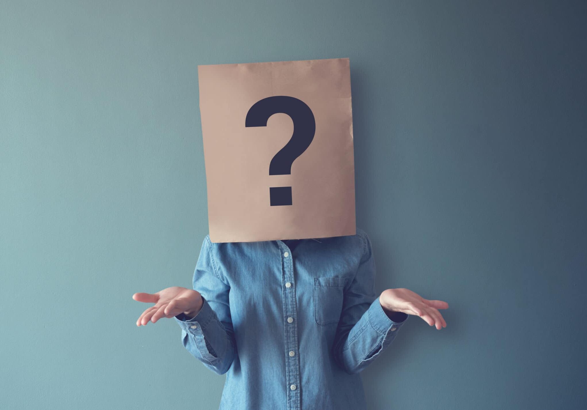Woman has Confused, Thinking, Question Mark Icon on Paper Bag, copy space.